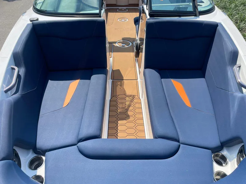 Slide: The Image of 2021 MasterCraft NXT 24 boat interior with blue seating and orange accents. - 10