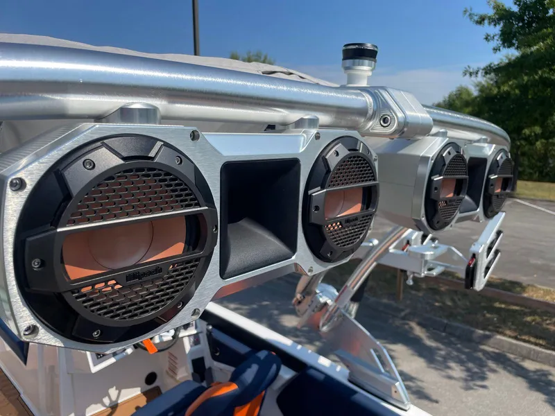Slide: The Image of 2021 MasterCraft NXT 24 boat speakers and tower in a sunny outdoor setting. - 17