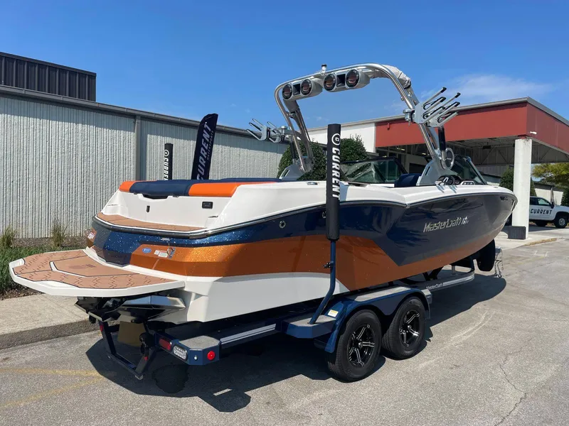 Slide: The Image of 2021 MasterCraft NXT 24 boat on trailer, featuring sleek design and vibrant colors. - 5