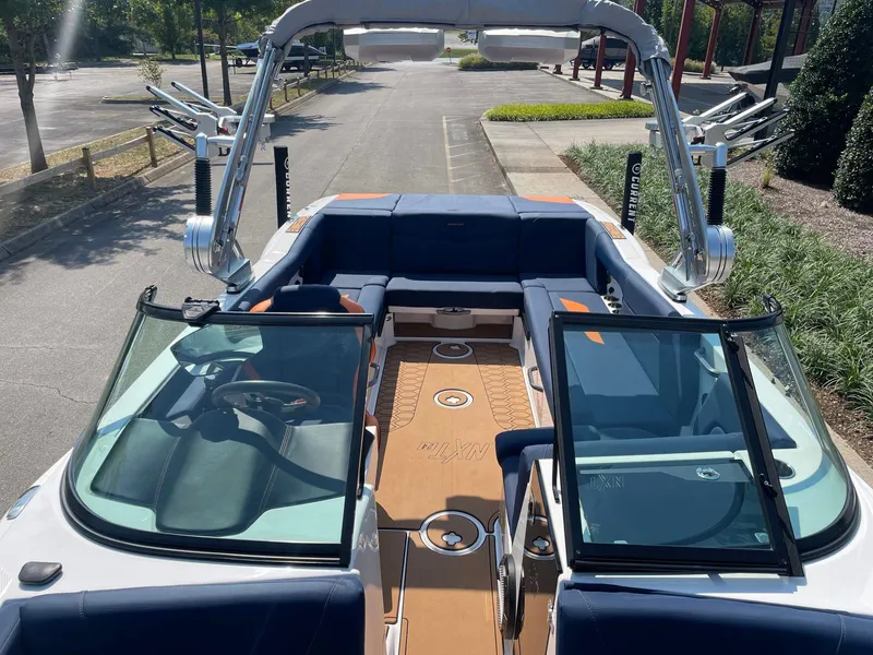 Slide: The Image of 2021 MasterCraft NXT 24 boat interior with open windshield and seating area. - 9