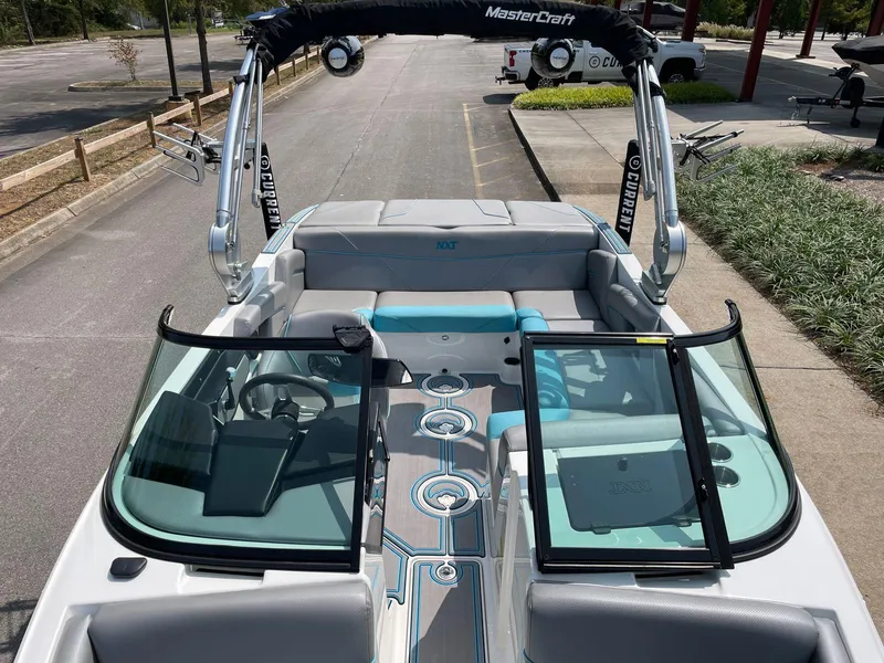 Slide: The Image of 2018 MasterCraft NXT20 boat interior with open windshield and seating. - 10