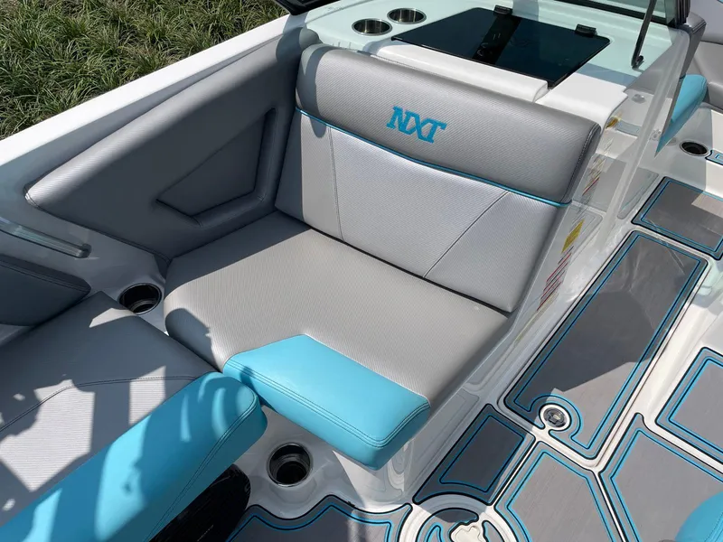 Slide: The Image of 2018 MasterCraft NXT20 boat interior with gray and blue seating and stylish design. - 8