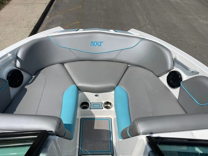 Slide: The Image of 2018 MasterCraft NXT20 boat interior with gray and blue seating. - 9