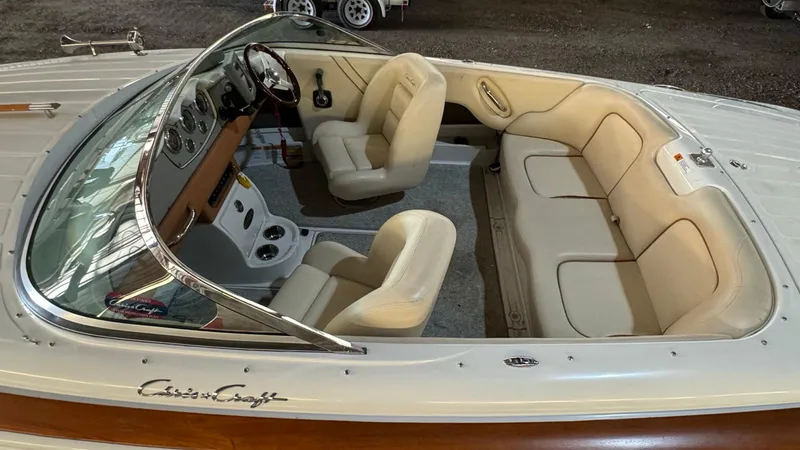 Slide: The Image of 2006 Chris-Craft Speedster boat interior with cream leather seats and classic dashboard. - 4