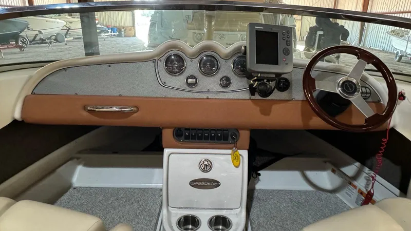Slide: The Image of 2006 Chris-Craft Speedster dashboard with steering wheel and navigation system. - 5