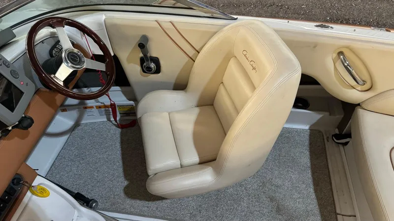 Slide: The Image of 2006 Chris-Craft Speedster interior with beige leather seat and wooden steering wheel. - 6