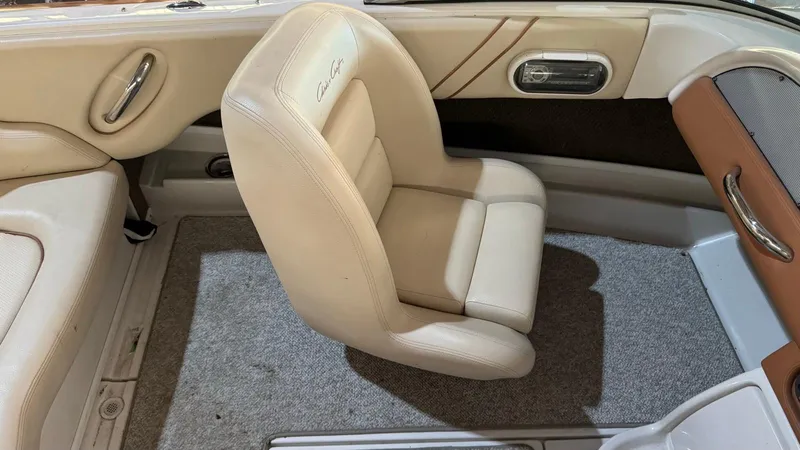 Slide: The Image of 2006 Chris-Craft Speedster interior with beige leather seats and carpeted flooring. - 7