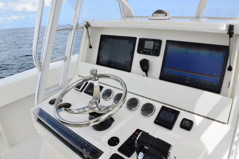 Slide: The Image of 2020 SeaVee 370z boat dashboard with steering wheel and navigation screens. - 21