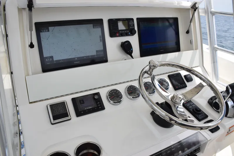 Slide: The Image of 2020 SeaVee 370z boat dashboard with navigation screens and steering wheel. - 23