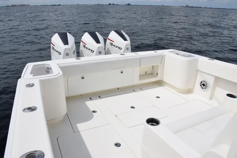 Slide: The Image of 2020 SeaVee 370z boat deck with triple outboard engines on open water. - 26