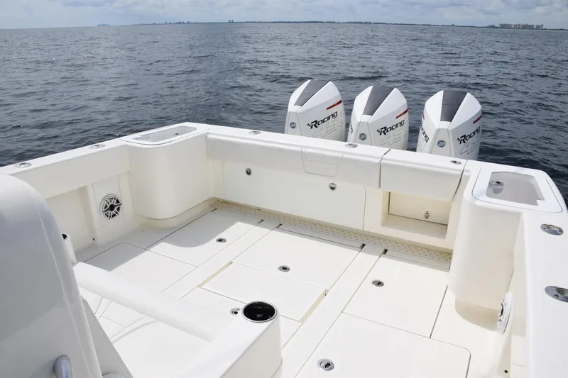 Slide: The Image of 2020 SeaVee 370z boat deck with triple outboard engines on open water. - 27