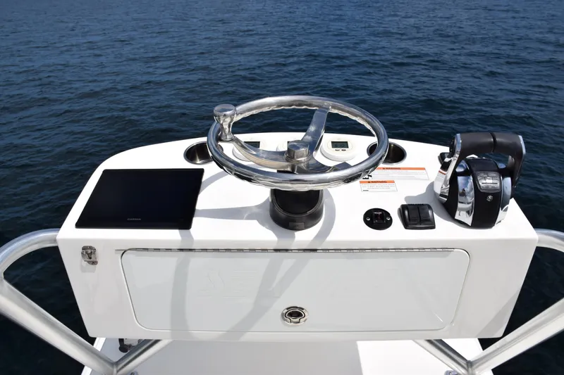 Slide: The Image of 2020 SeaVee 370z boat helm with steering wheel and controls on open water. - 34