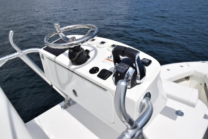 Slide: The Image of SeaVee 370z 2020 boat helm with steering wheel and controls on open water. - 36