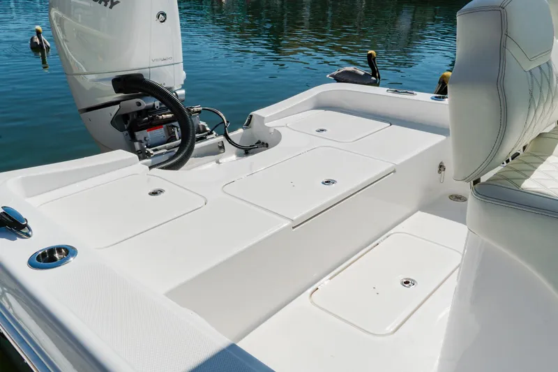 Slide: The Image of 2024 Blackwater 23 Hybrid boat deck with storage compartments and outboard motor. - 10