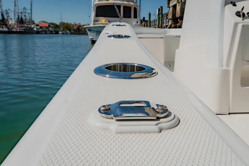 Slide: The Image of 2024 Blackwater 23 Hybrid boat detail with chrome fittings on deck, docked in marina. - 17