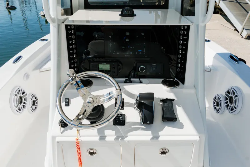 Slide: The Image of 2024 Blackwater 23 Hybrid boat console with steering wheel and control panel. - 20