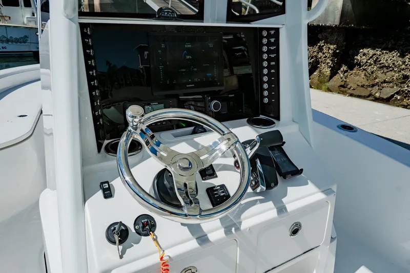 Slide: The Image of 2024 Blackwater 23 Hybrid boat dashboard with steering wheel and control panel. - 21