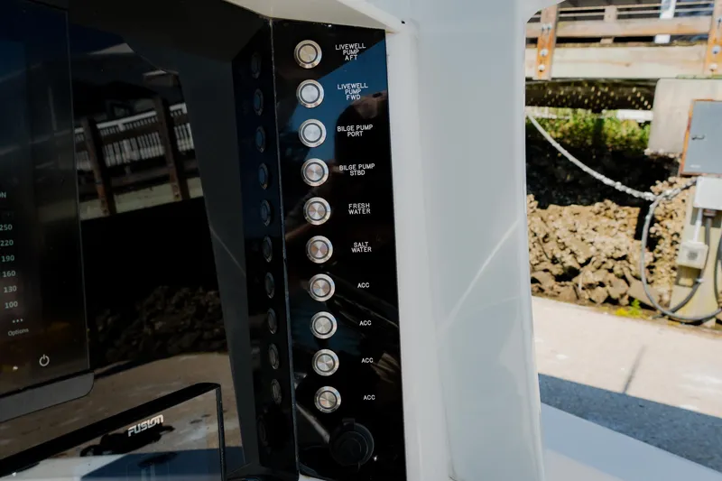 Slide: The Image of Control panel of 2024 Blackwater 23 Hybrid boat with labeled switches and buttons. - 25