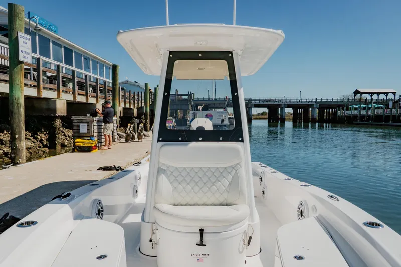 Slide: The Image of 2024 Blackwater 23 Hybrid boat docked at marina, showcasing sleek design and spacious seating. - 28