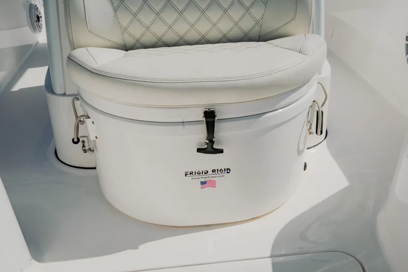 Slide: The Image of White cushioned seat on 2024 Blackwater 23 Hybrid boat, featuring Frigid Rigid cooler. - 29