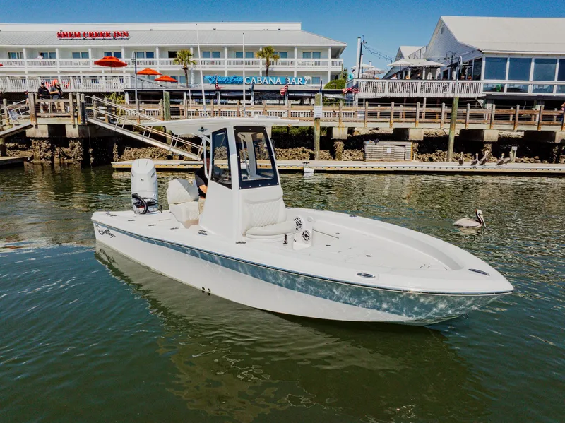 Slide: The Image of 2024 Blackwater 23 Hybrid boat docked near waterfront restaurants. - 3