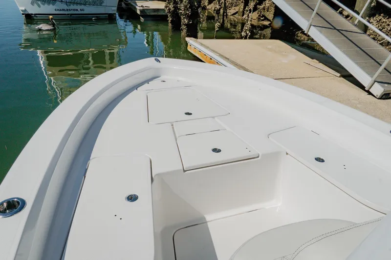 Slide: The Image of 2024 Blackwater 23 Hybrid boat docked, showcasing sleek white deck design. - 30