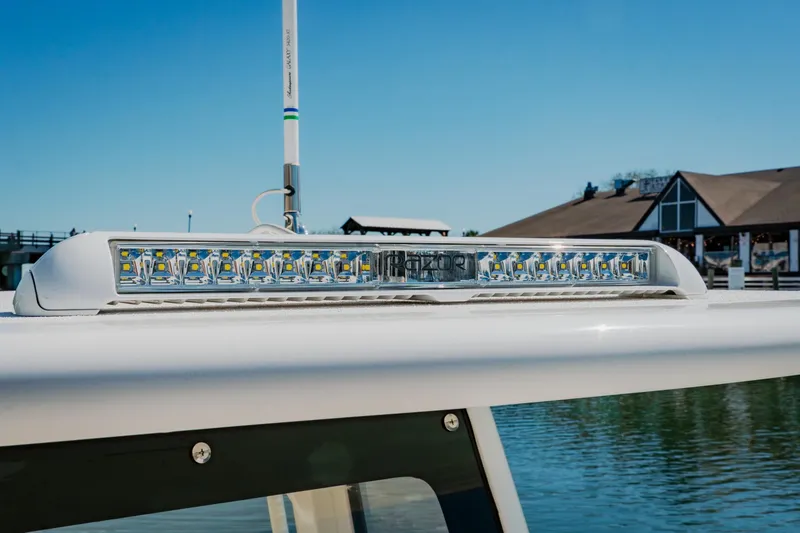 Slide: The Image of 2024 Blackwater 23 Hybrid boat with LED light bar, docked by a waterfront building. - 34