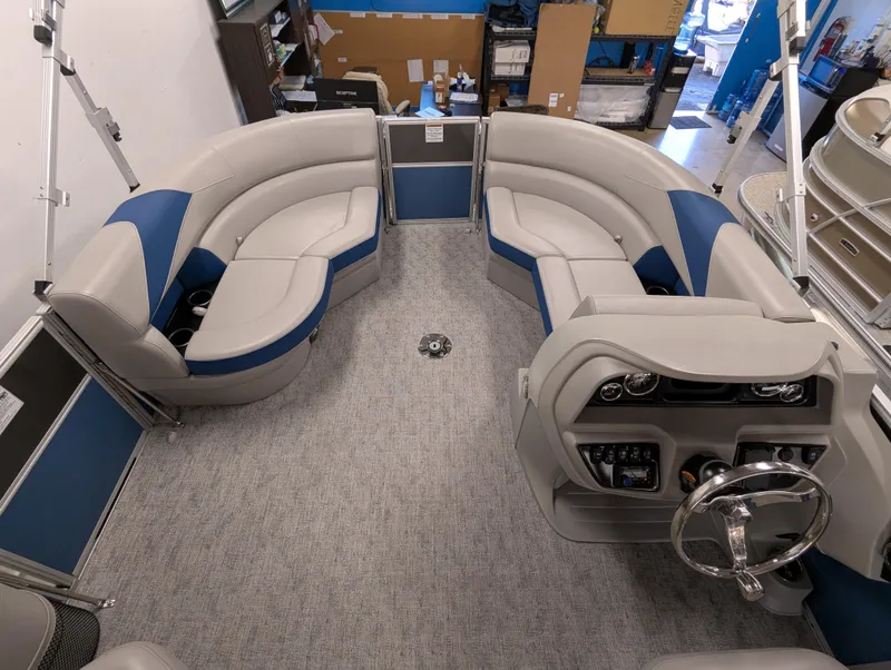 Slide: The Image of 2025 Trifecta 22UL LE T pontoon boat displayed indoors with canopy. - 9