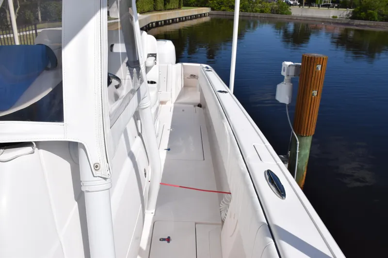 Slide: The Image of 2017 Intrepid 327 boat docked by calm water, showcasing sleek white deck design. - 21
