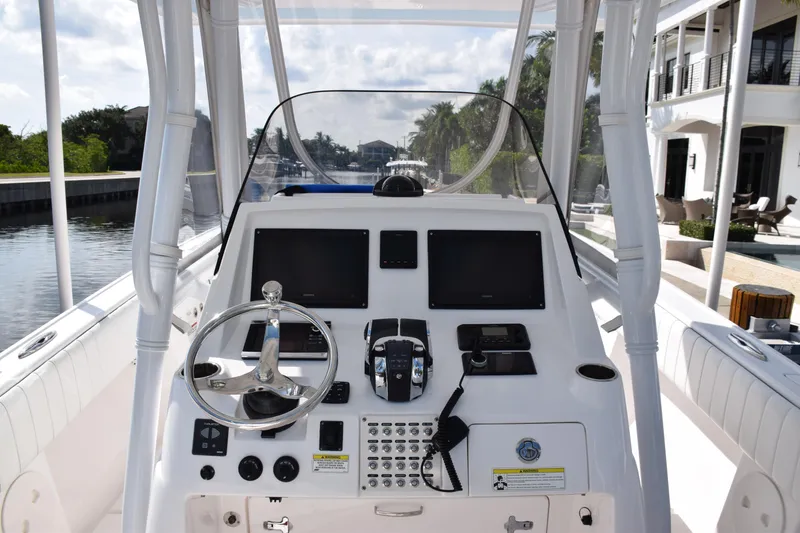 Slide: The Image of 2017 Intrepid 327 boat dashboard with steering wheel and navigation controls. - 24