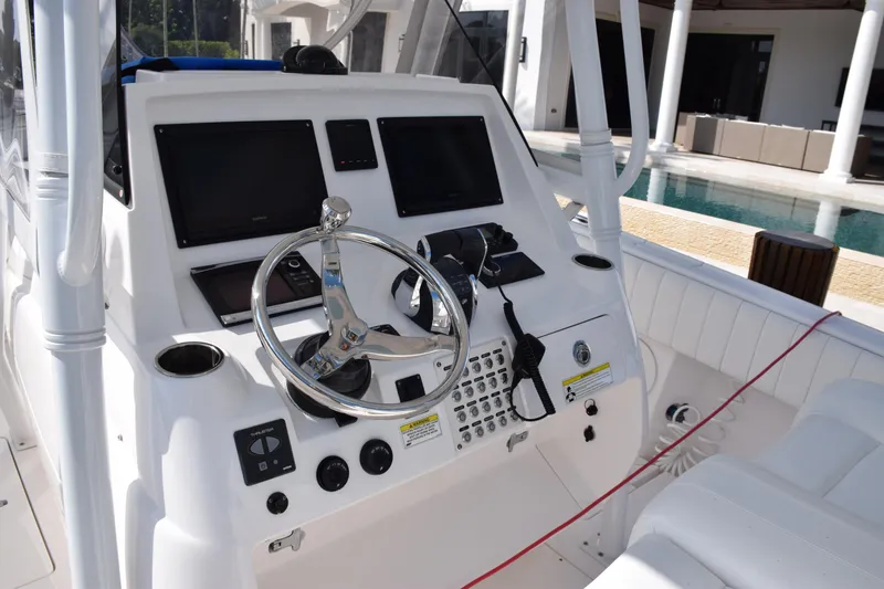 Slide: The Image of 2017 Intrepid 327 boat cockpit with steering wheel and control panel. - 26