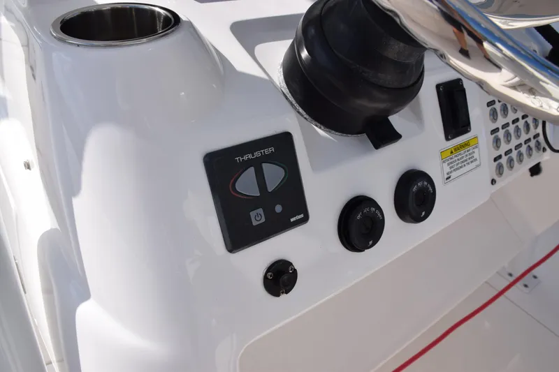 Slide: The Image of 2017 Intrepid 327 boat control panel with thruster and steering wheel. - 27