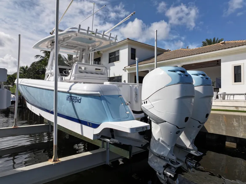 Slide: The Image of 2017 Intrepid 327 boat docked near luxury waterfront home. - 3