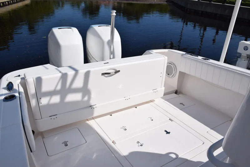 Slide: The Image of 2017 Intrepid 327 boat deck with dual engines, docked on calm water. - 37