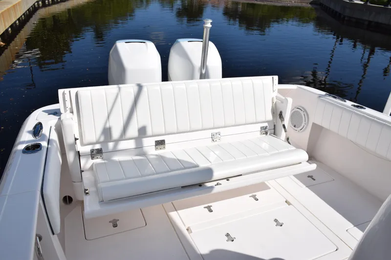 Slide: The Image of 2017 Intrepid 327 boat with white seating and dual engines on calm water. - 46