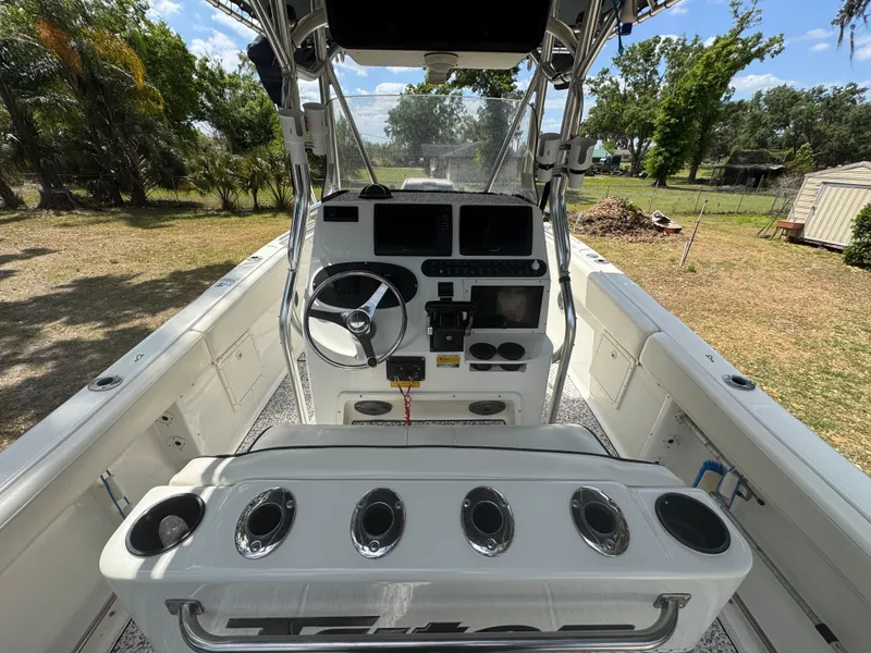 Slide: The Image of 2003 Triton 2690 CC boat cockpit with steering wheel and control panel. - 20