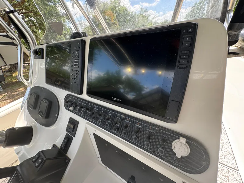 Slide: The Image of Console of a 2003 Triton 2690 CC boat with Garmin navigation screens. - 23