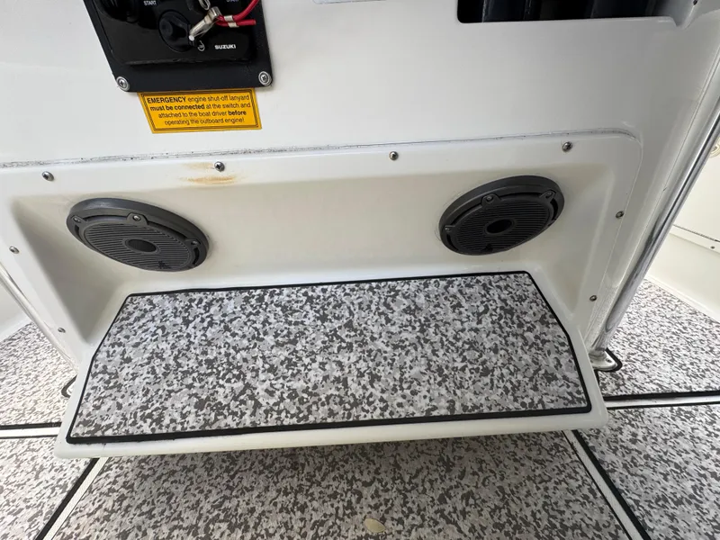 Slide: The Image of 2003 Triton 2690 CC boat interior with speakers and textured flooring. - 27