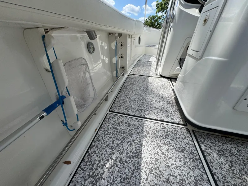 Slide: The Image of 2003 Triton 2690 CC boat interior with textured flooring and storage compartments. - 29