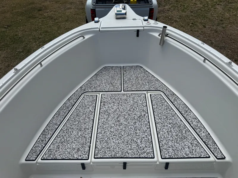 Slide: The Image of 2003 Triton 2690 CC boat deck with textured flooring, viewed from above. - 35