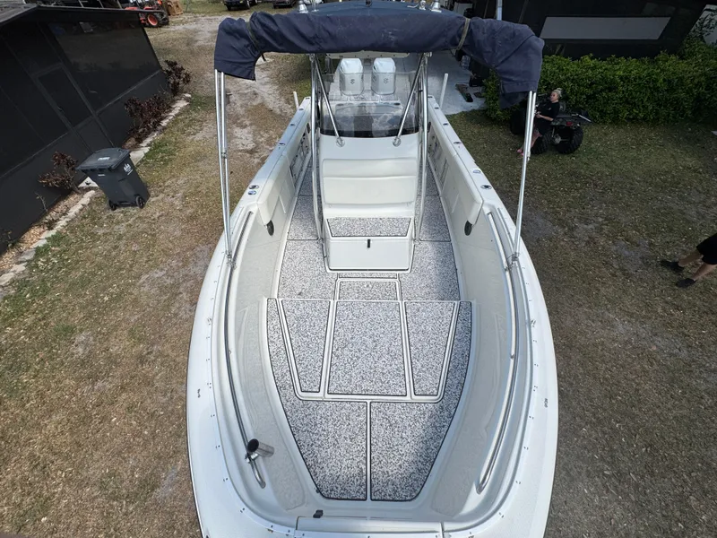 Slide: The Image of 2003 Triton 2690 CC boat with spacious deck and canopy, viewed from above. - 38