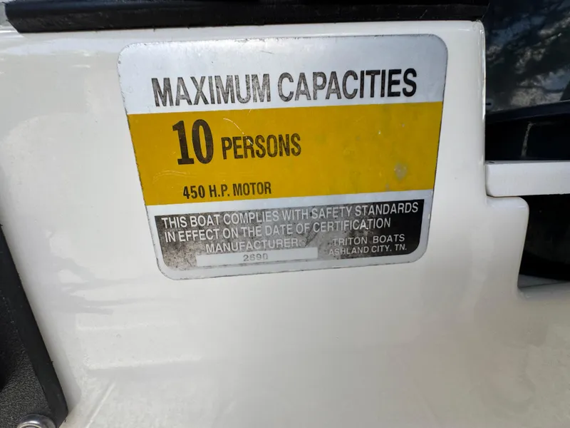 Slide: The Image of 2003 Triton 2690 CC capacity label, max 10 persons, 450 HP motor compliance. - 44