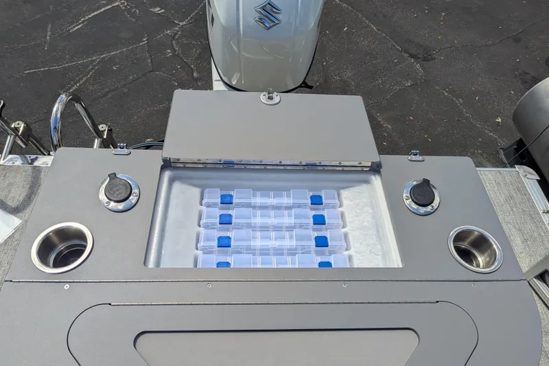Slide: The Image of 2026 Trifecta 22TRFC LE boat storage compartment with cup holders and tackle boxes. - 11