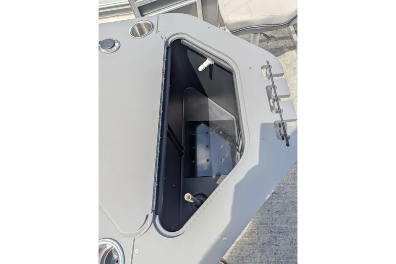Slide: The Image of 2026 Trifecta 22TRFC LE boat storage compartment with cup holder and seating area. - 12