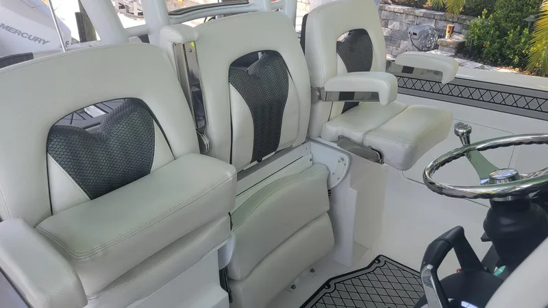 Slide: The Image of 2023 Wellcraft 352 Fisherman boat interior with plush seating and steering wheel. - 14