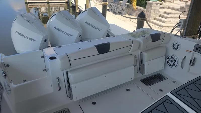 Slide: The Image of 2023 Wellcraft 352 Fisherman boat with Mercury engines, featuring a spacious deck and seating area. - 15