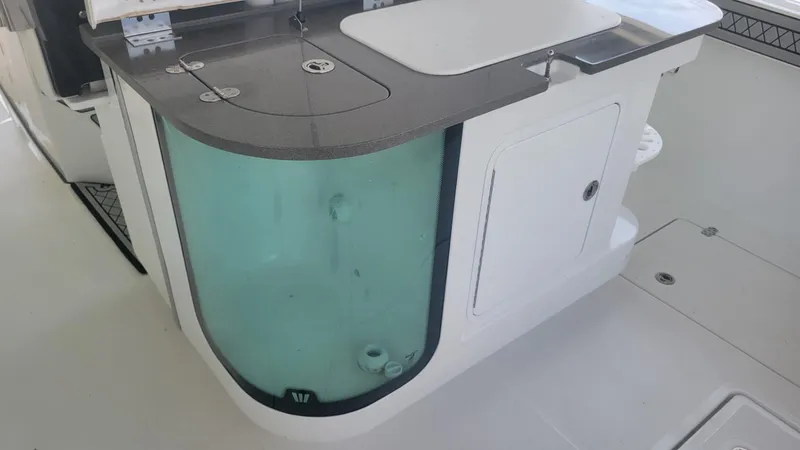 Slide: The Image of 2023 Wellcraft 352 Fisherman boat interior with livewell and storage compartments. - 19