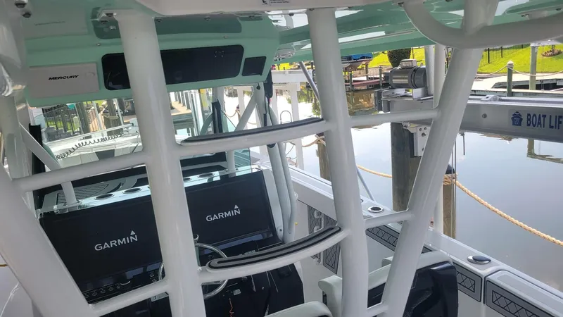 Slide: The Image of 2023 Wellcraft 352 Fisherman boat interior with Garmin navigation system at dock. - 22