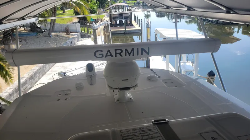 Slide: The Image of 2023 Wellcraft 352 Fisherman boat with Garmin radar, docked under a canopy. - 24
