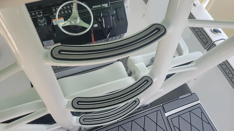 Slide: The Image of 2023 Wellcraft 352 Fisherman boat interior with steering wheel and seating area. - 25